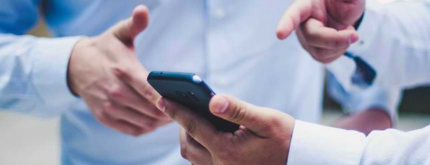 A person sits and browses through their smartphone, after learning how to choose a cell phone plan.
