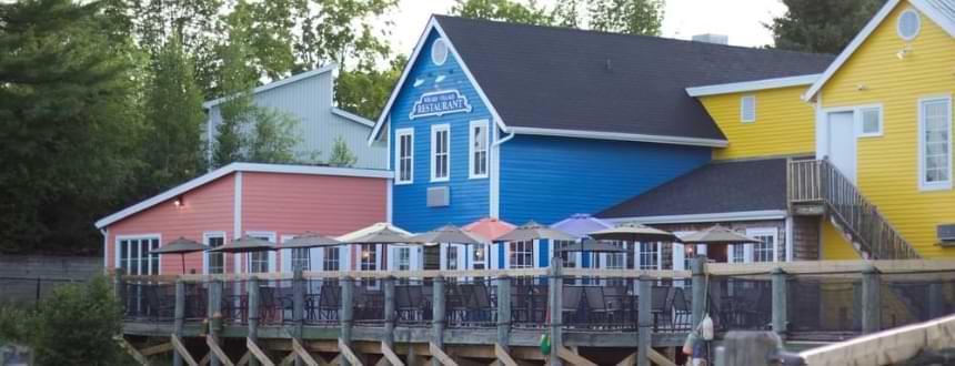 Three colorful houses in rural New Brunswick. where Rogers internet will soon become widely available.