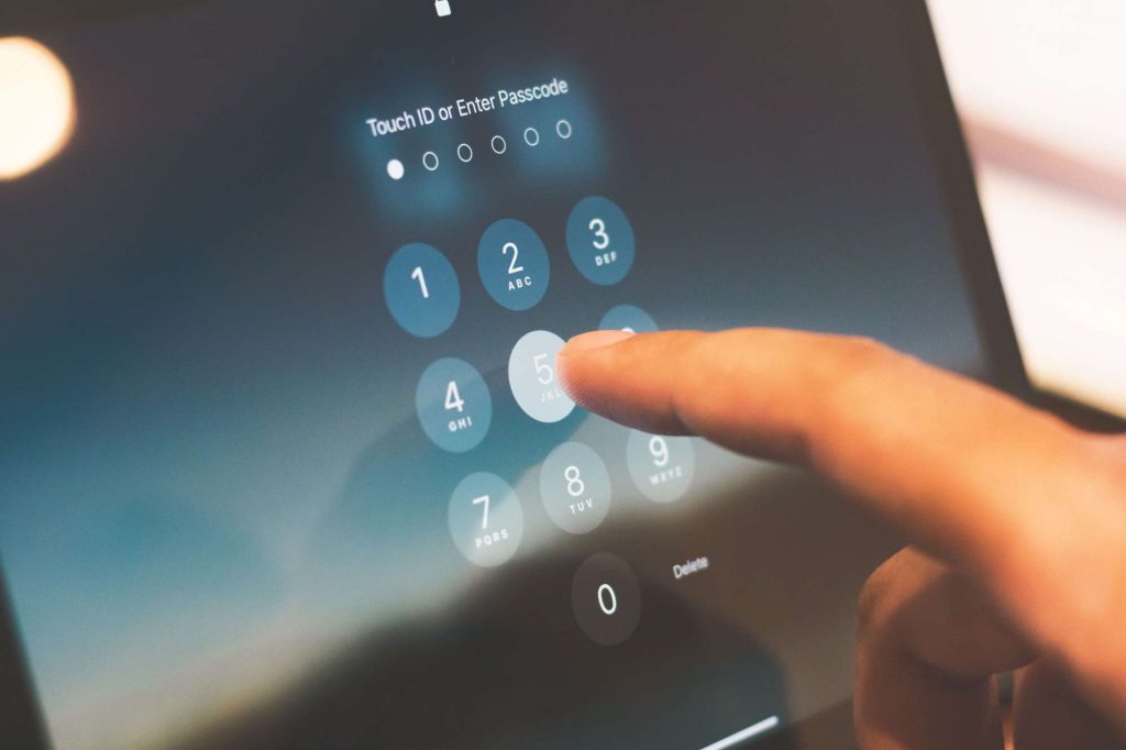Finger entering the security passcode on a smartphone