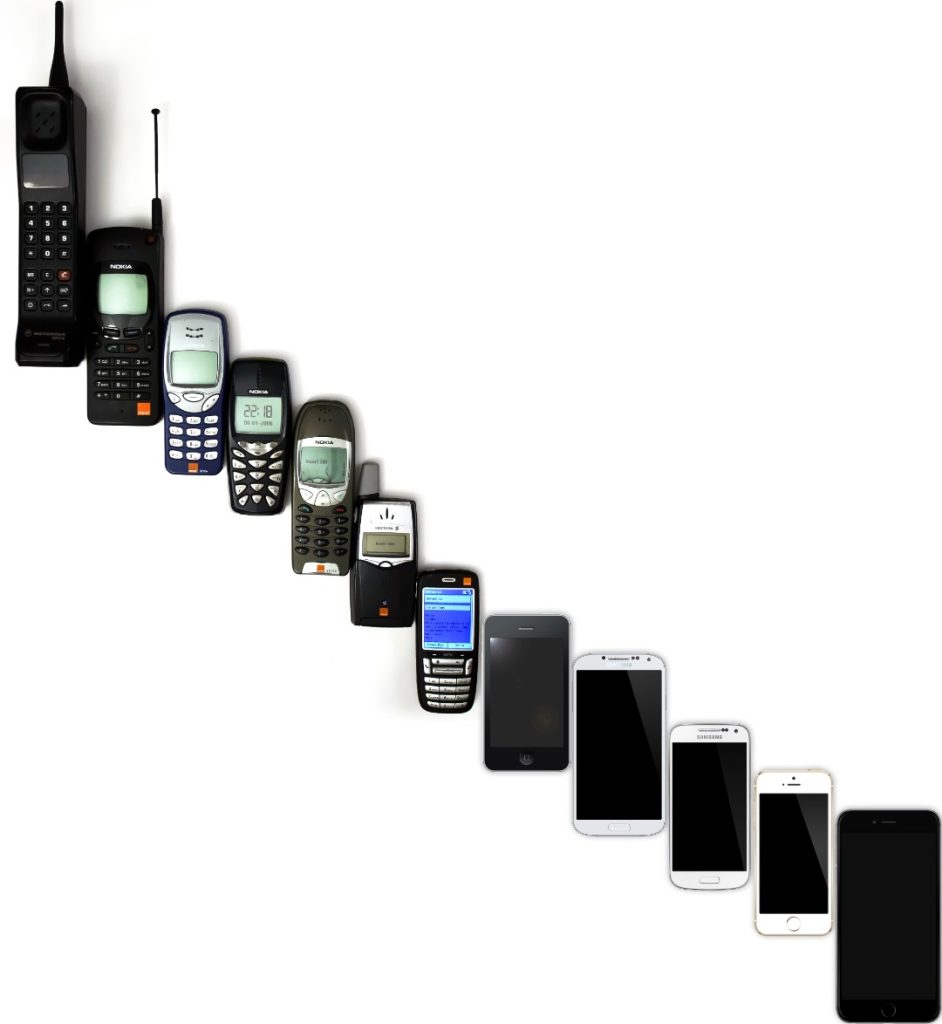 Different generations of mobile phones arranged from older models to modern smartphones