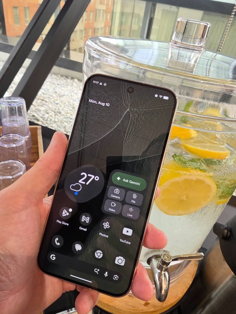 Google Pixel 11 Pro XL in Olive held in one hand and shown from the front