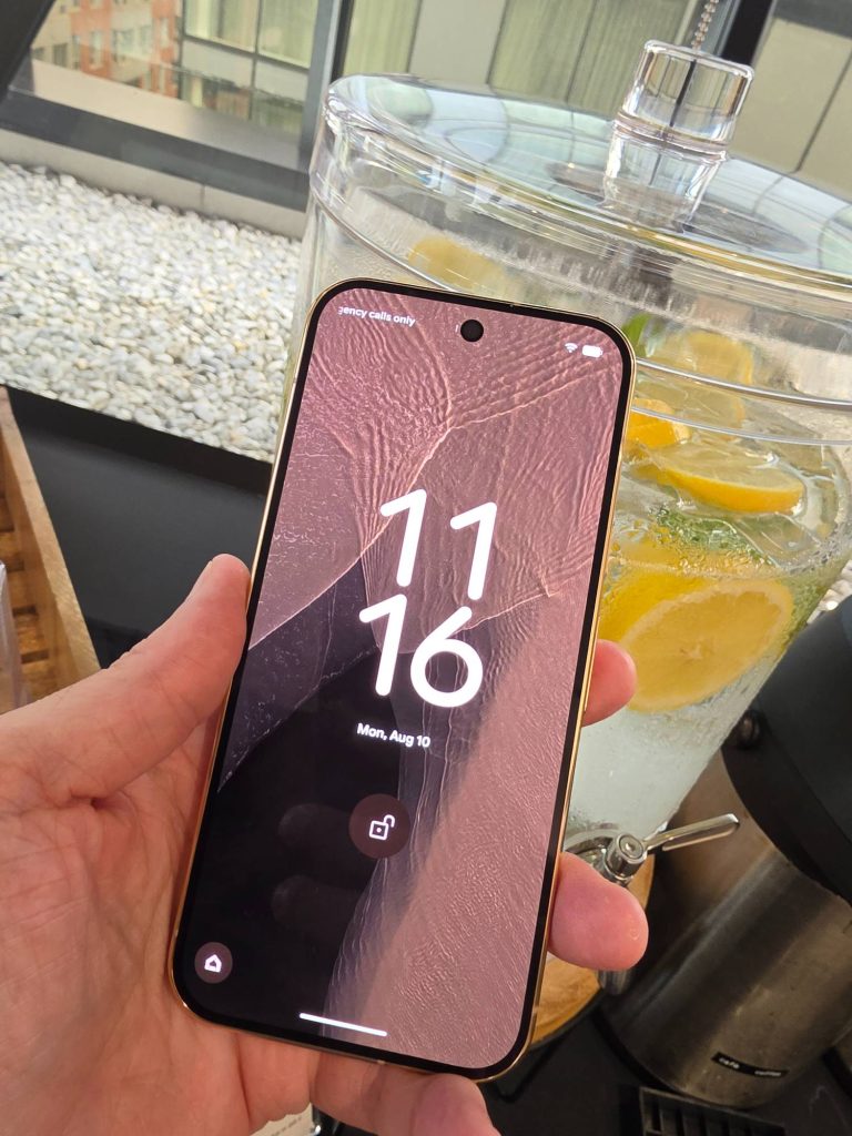 Google Pixel 11 Pro in Canyon held in one hand and shown from the front